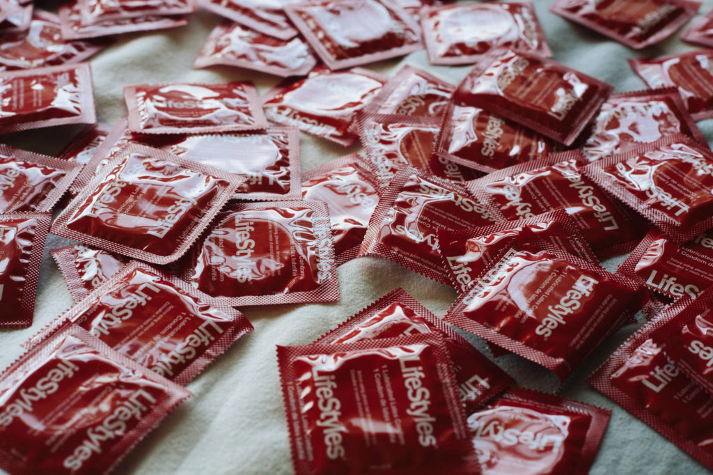 LifeStyles condoms lay scattered on a bed. |Cam Peters