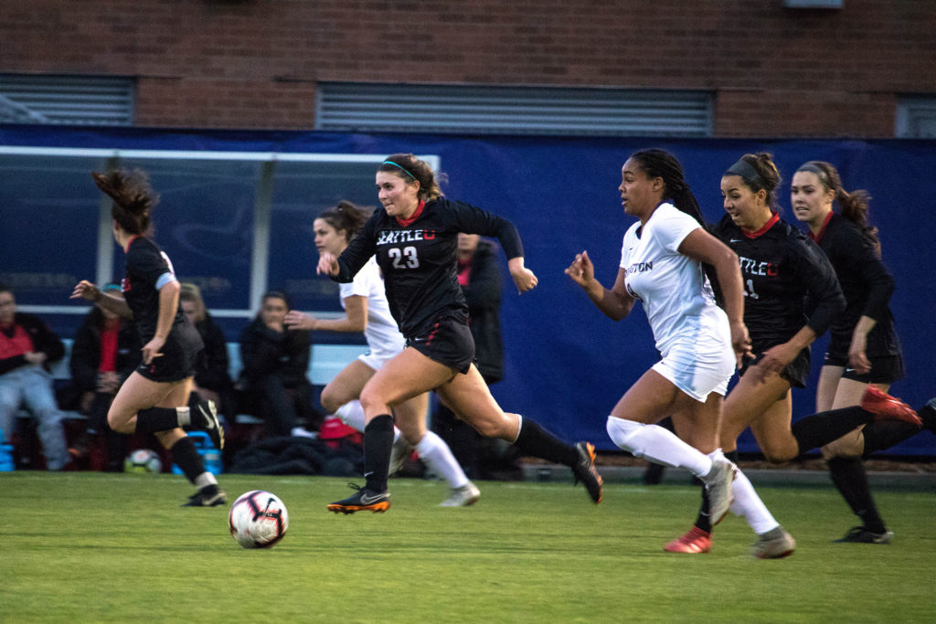 Junior Midfielder, Holly Rothering, dribbles past UW player as she charges to the goal. 