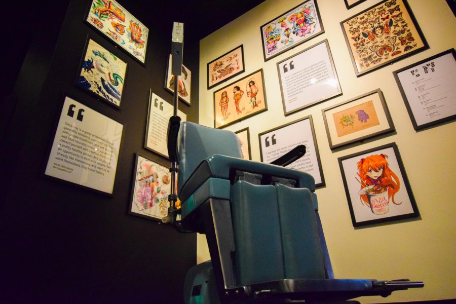 In the Body of Work exhibit at the Museum of Pop Culture, a recreation of a tattoo parlor allows visitors to try on hologram designs.