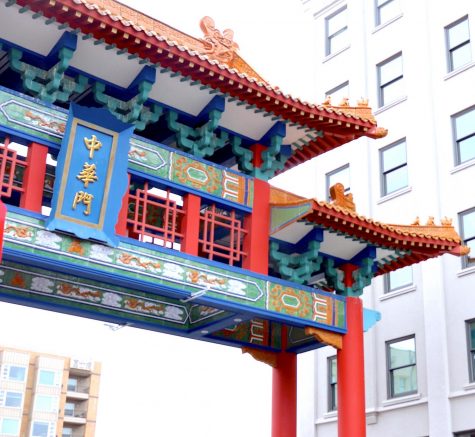 Intricate colorful archway contrasts the grays of the surrounding buildings and sky.
