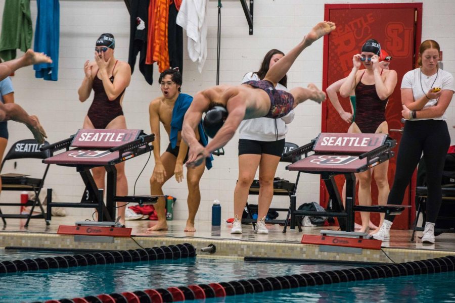 Seattle University swimmer dives into the water.