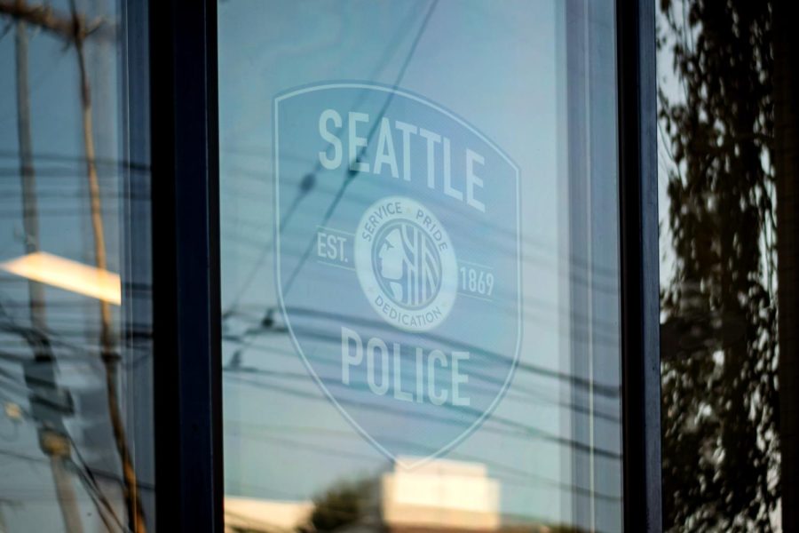 A Seattle Police department car parked in a reserved spot near the entrance to the East Precinct.