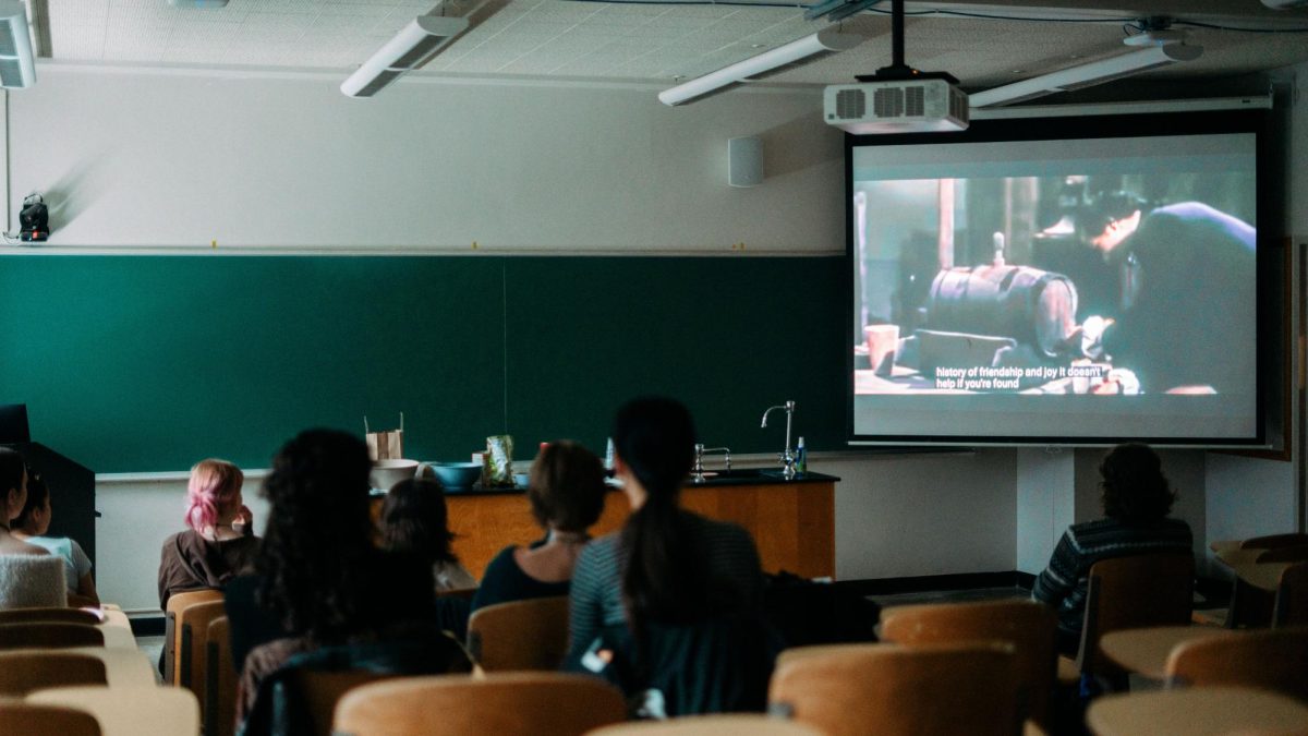 Students watch a documentary about the practices of the Coca-Cola Company.