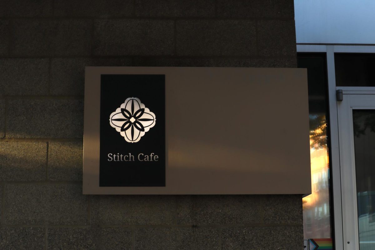 A plaque with Stitch Cafe’s logo and name.