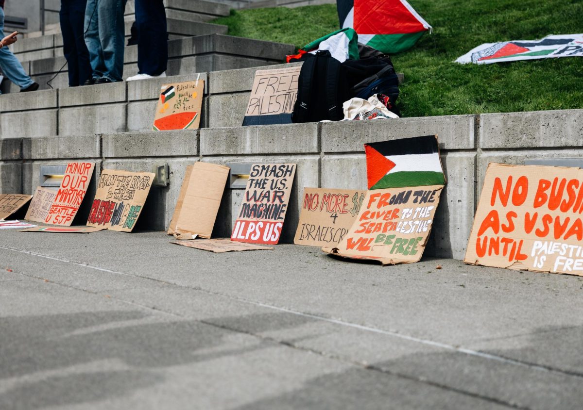 Protest signs on display against the steps during the rally. 