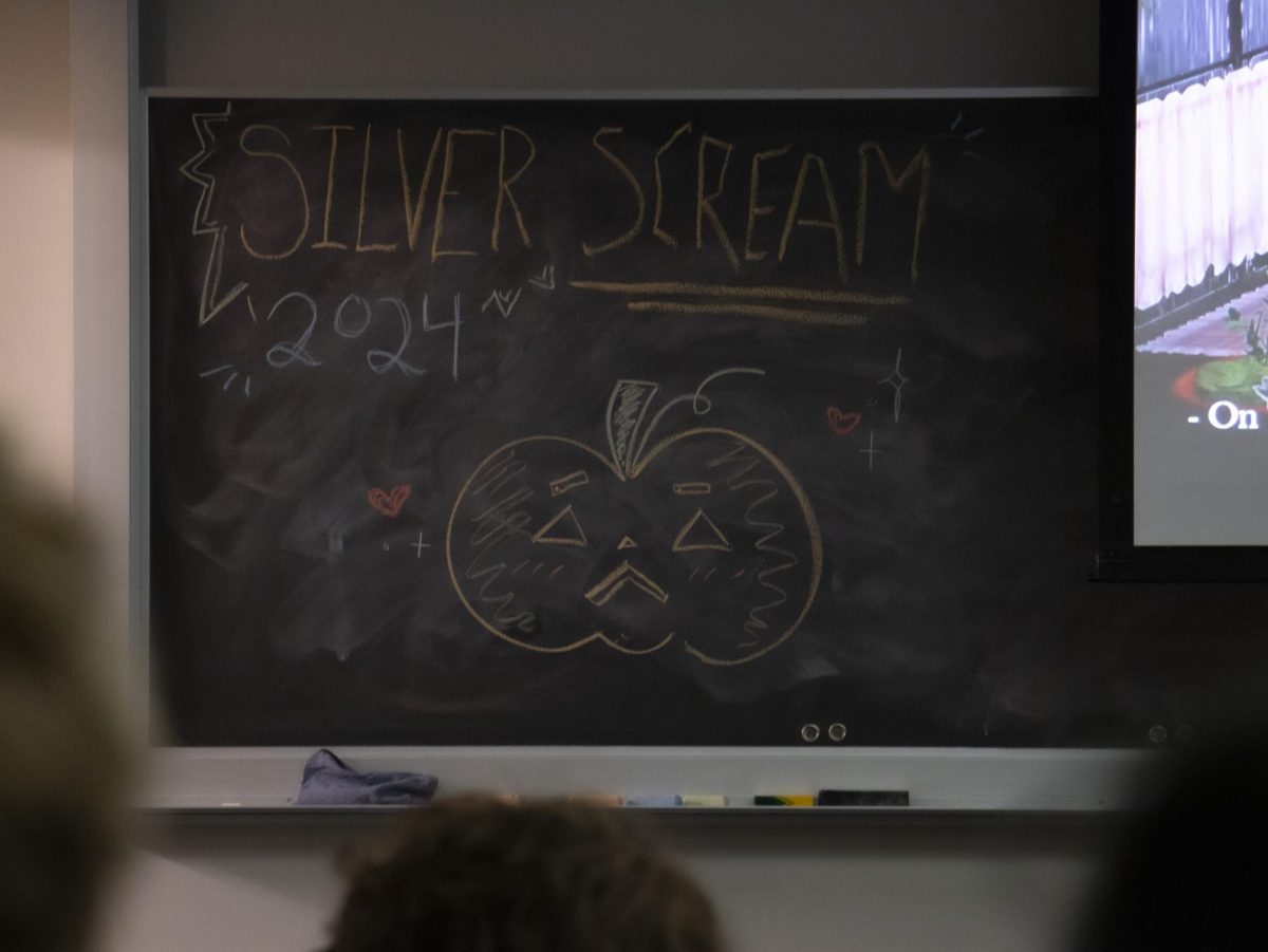 A chalkboard drawing welcomes attendees to the event.