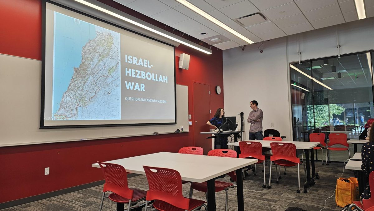 Dr. Nova Robinson and Dr. Felipe Murtinho converse before the teach-in.