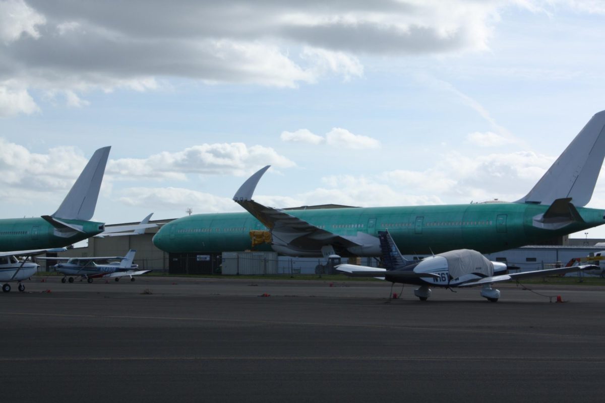 A Boeing Jet is parked outside a hangar at Paine Airfield.