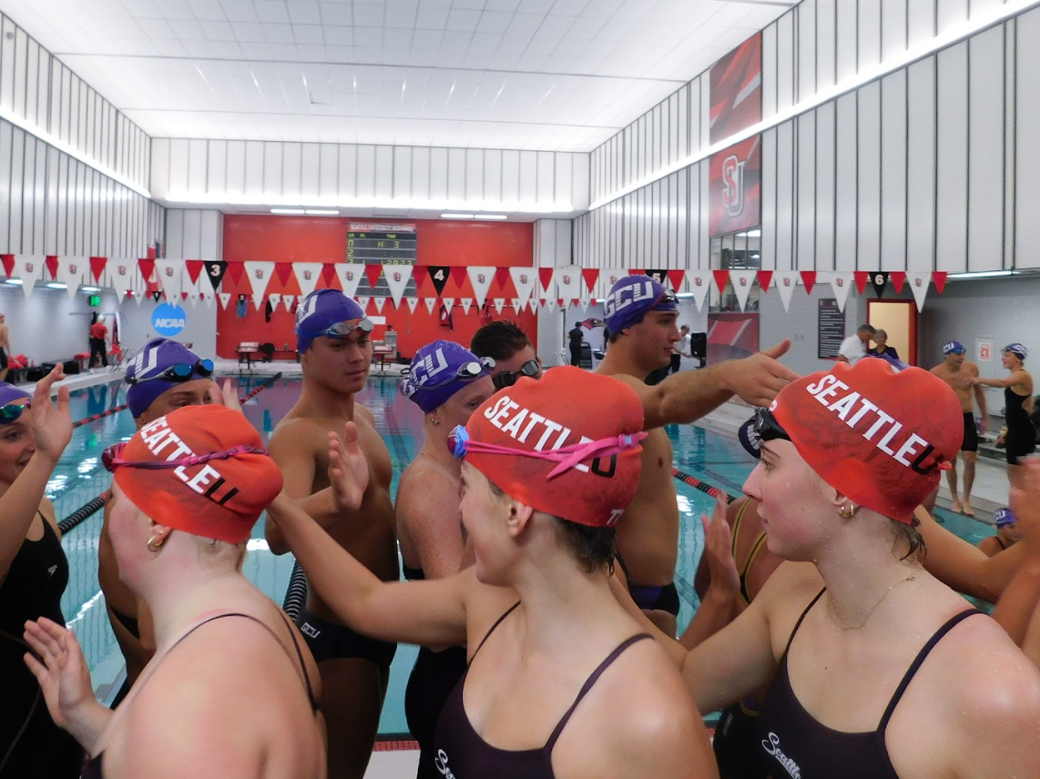 SU swimmers high five GCU swimmers after Saturday’s meet.