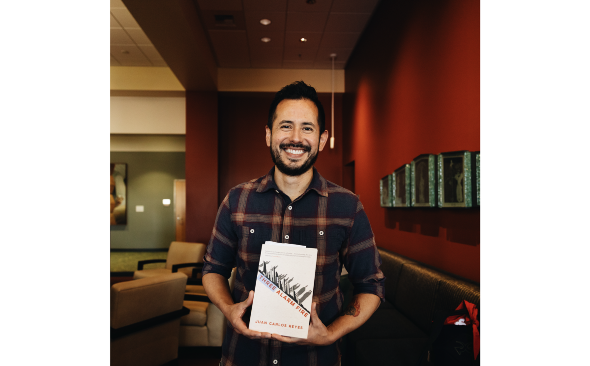 Dr. Reyes holding up his book for the book launch.