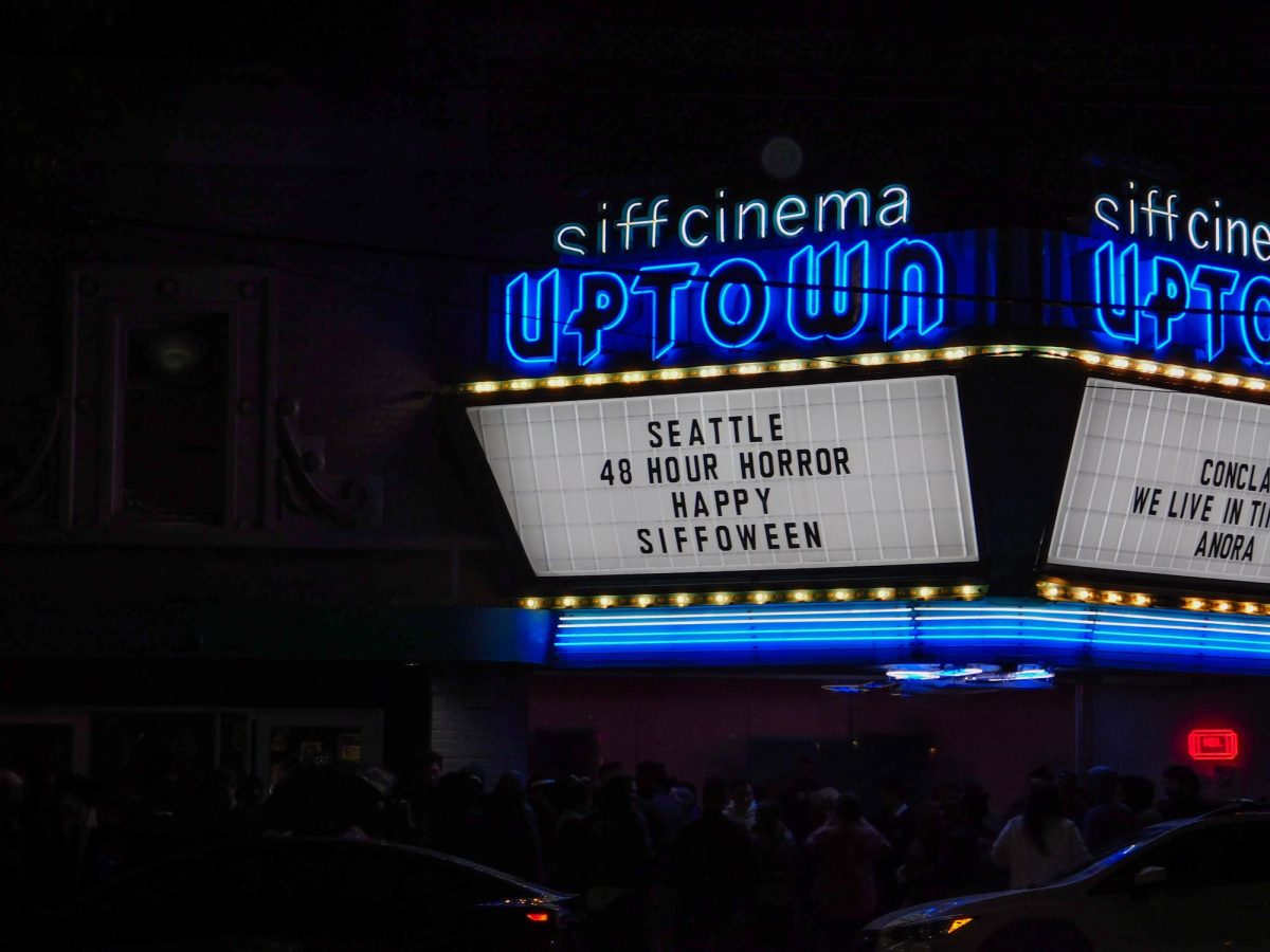 The SIFF Cinema Uptown marquee display illuminates the street.