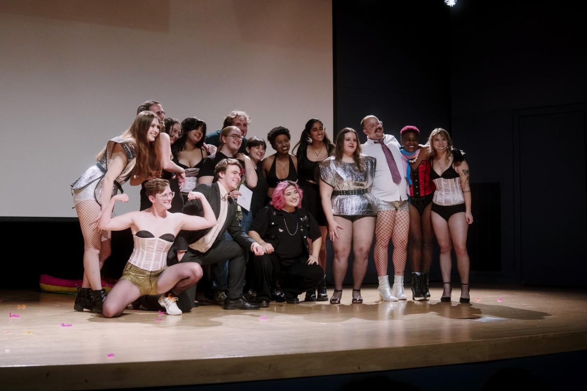 The 2024 cast and crew of The Rocky Horror Picture Show gathers for a photo including director Toni Larsen ‘27.