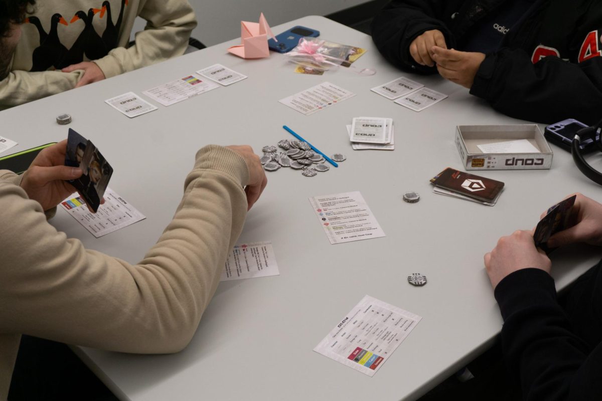 Math Club members focus on a card game during their weekly game night.