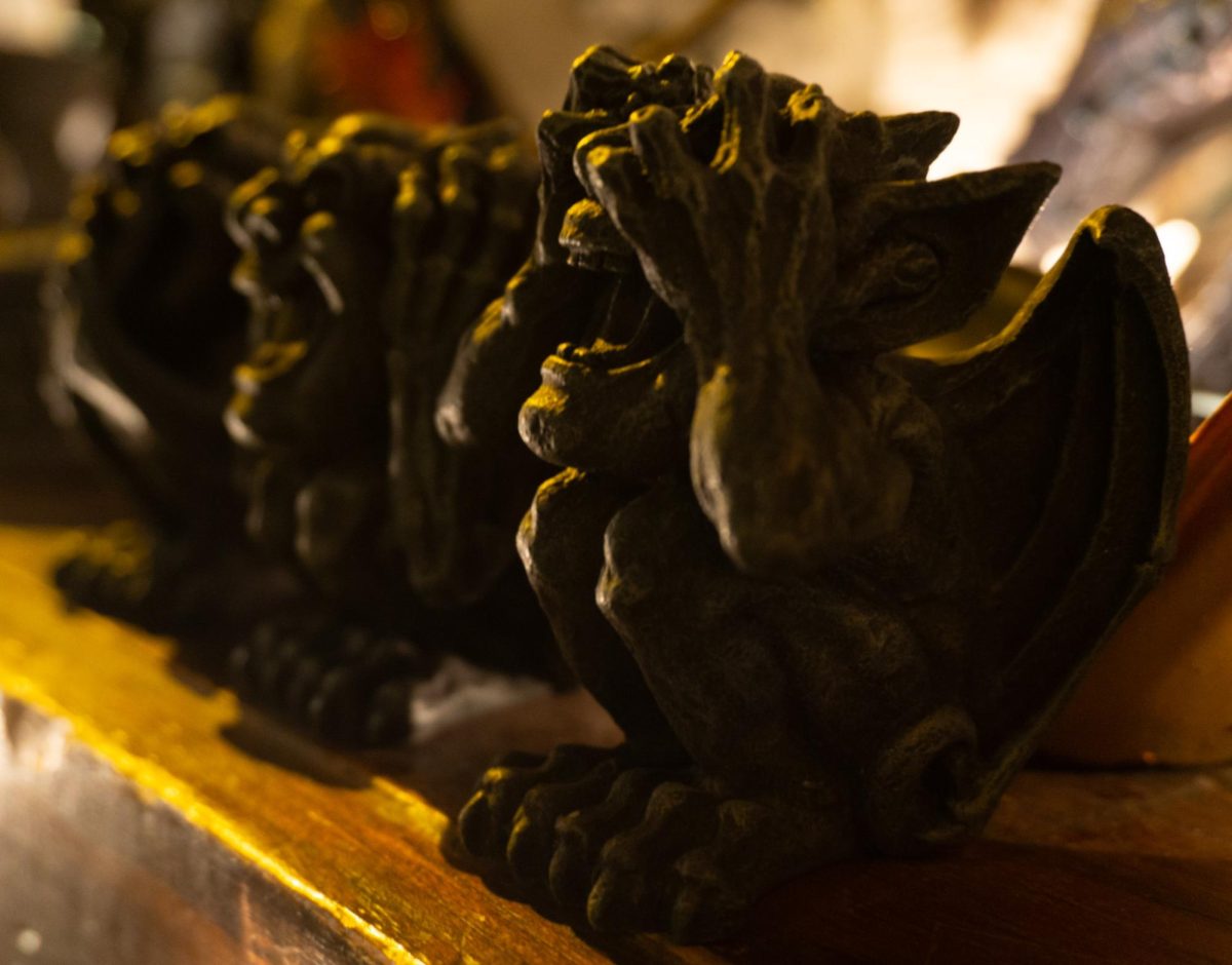 Three small matching gargoyles are displayed in a row.