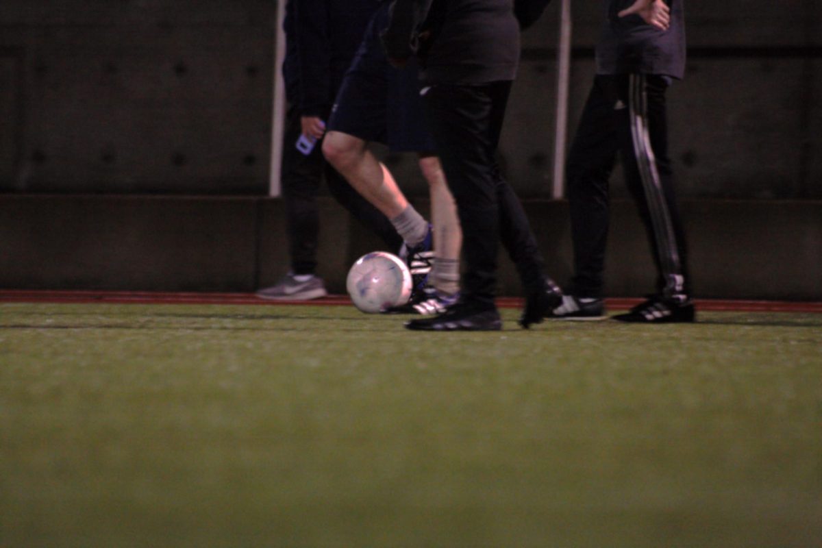 Intramural soccer players warm up at SU Park.