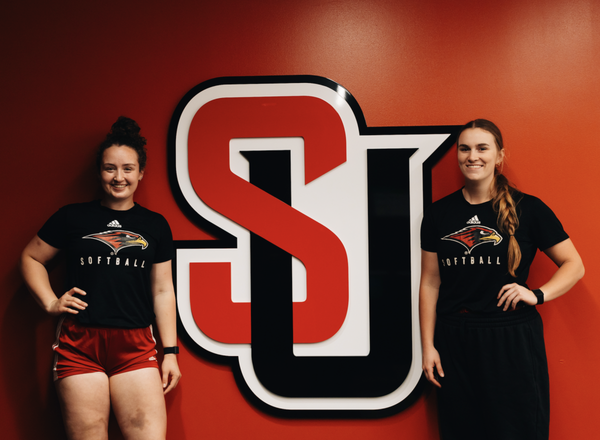 Picture of Taylor Fitch and Nicola Simpson against the Seattle University logo.