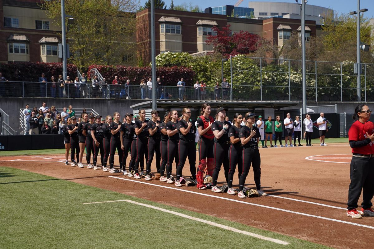 Seattle U Softball lined up and facing the flag during the national anthem.