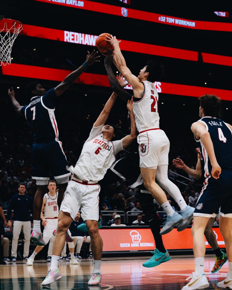 Senior forward Junseok Yeo and Sophomore center Houran Dan wrestle with Gonzaga players to secure a rebound 
