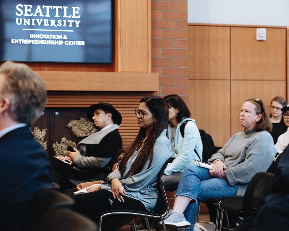 The audience listens to the panel discussion.