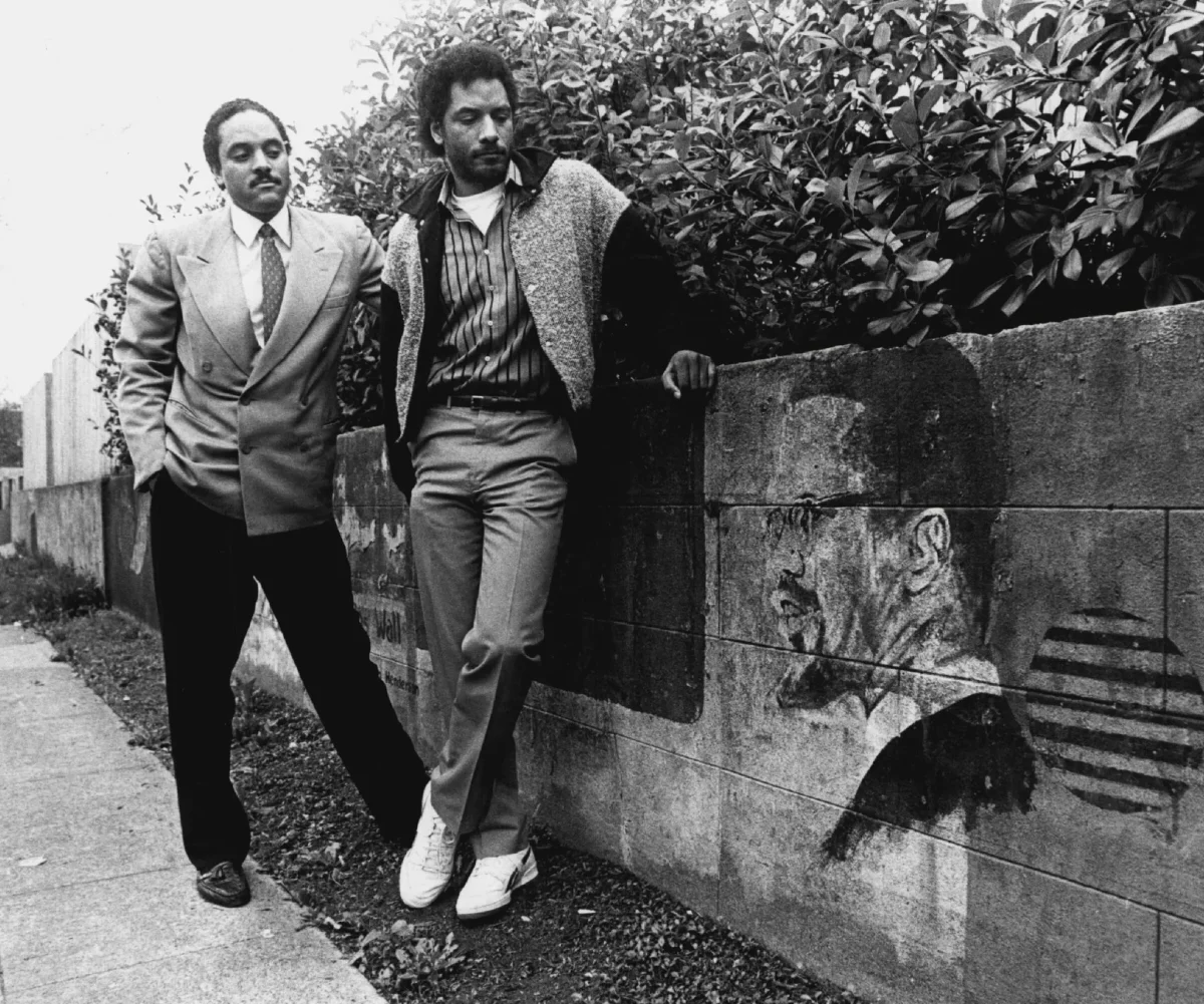 Elmer Dixon (left) and Aaron Dixon (right) look at The People's Wall, a mural dedicated to fallen members of the Black Panther Party of Seattle. [Courtesy of Aaron and Elmer Dixon.]