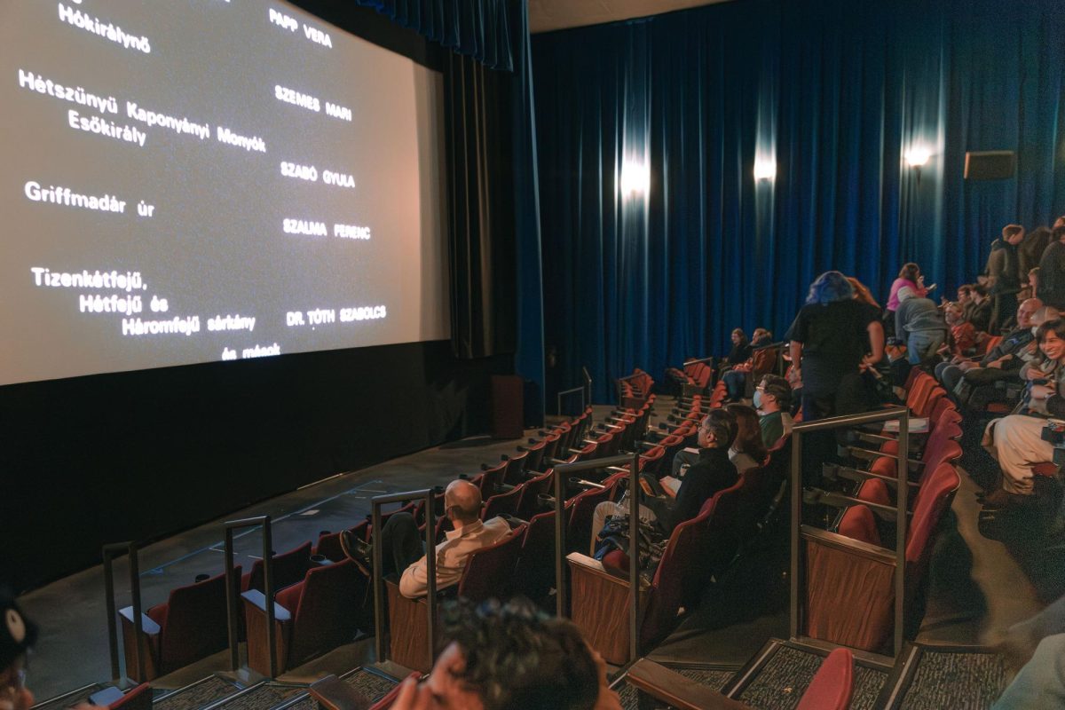The theater starts to empty as a film ends.
