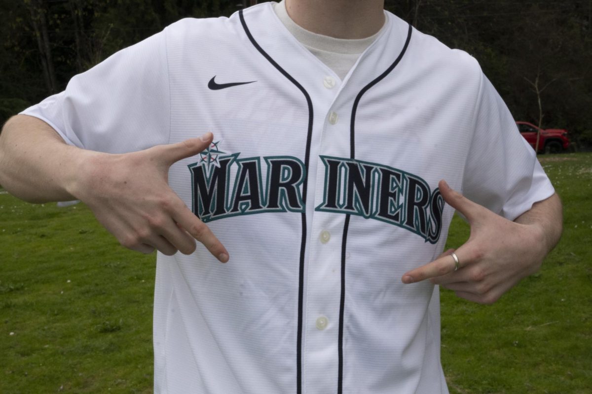 A Mariners fan shows off his jersey.