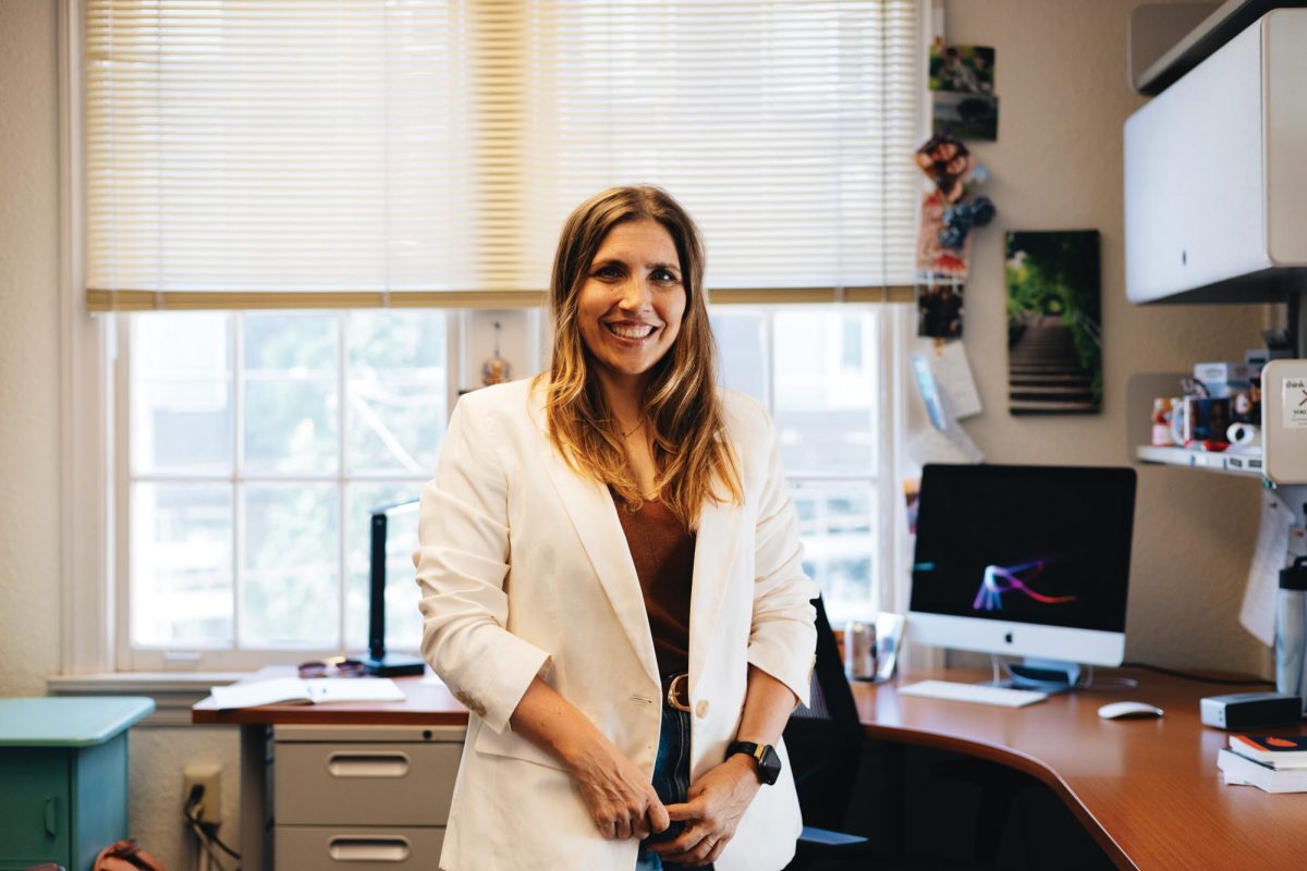 Dr. Carlson, Professor and Chair of the Communication and Media Department, poses in her office.