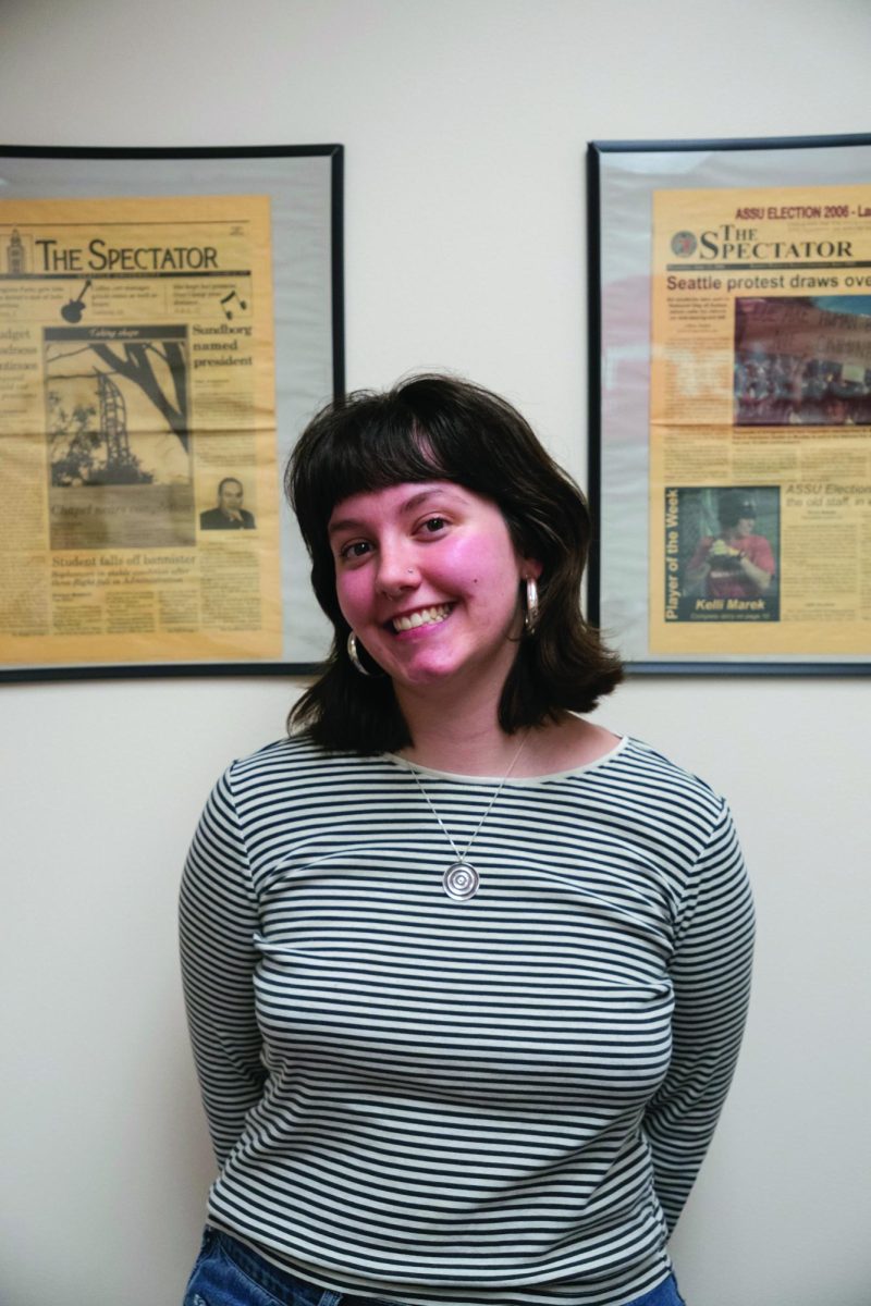 Graduating editor-in-chief, Leila Bunker, poses for a photo in front of old copies of The
Spectator.